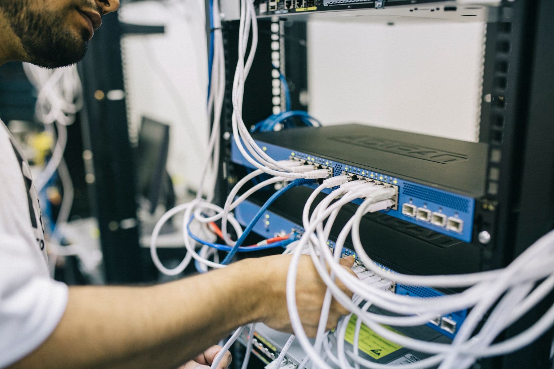 Network engineer commissioning rack-mounted infrastructure